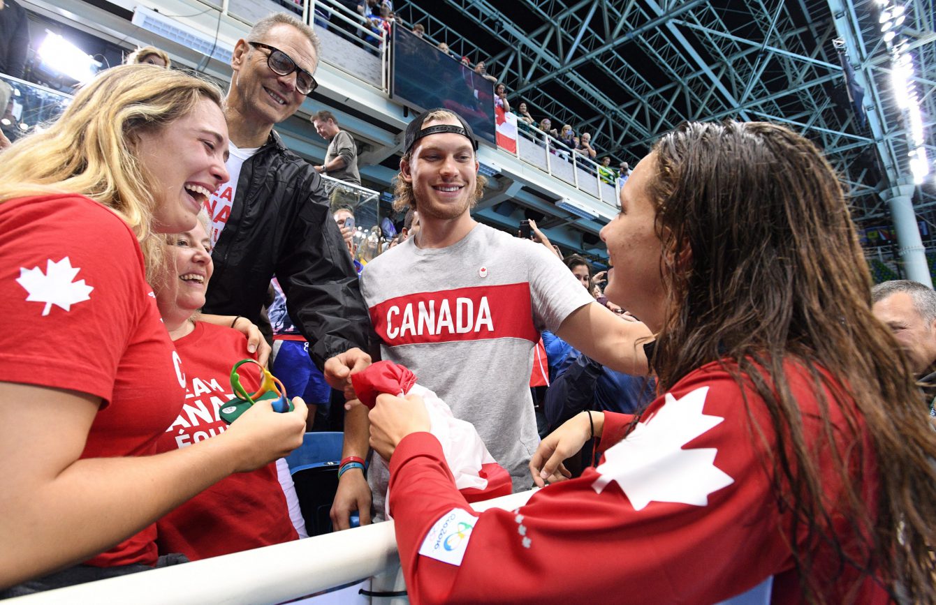 Canada's Penny Oleksiak celebrates her gold-medal win with family, including her brother, Dallas Stars' Jamie Oleksiak, second from right, in the women's 100m freestyle finals during the 2016 Olympic Summer Games in Rio de Janeiro, Brazil, on Friday, Aug. 12, 2016. THE CANADIAN PRESS/Sean Kilpatrick