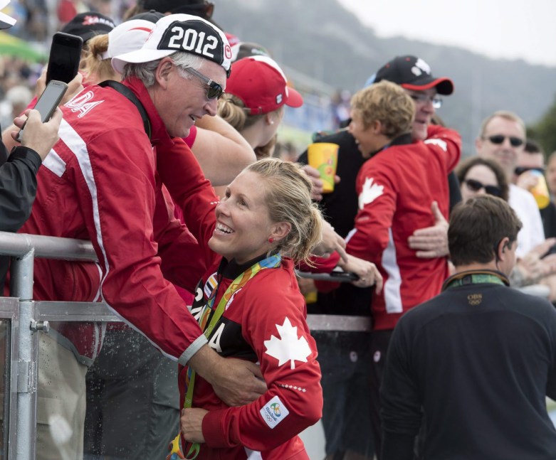 Canadian rowers Lindsay Jennerich and Patricia Obee, right, celebrate with family and supporters after winning a silver medal in the women's lightweight double sculls at the 2016 Summer Olympics in Rio de Janeiro, Brazil, Friday, Aug. 12, 2016. THE CANADIAN PRESS/Frank Gunn