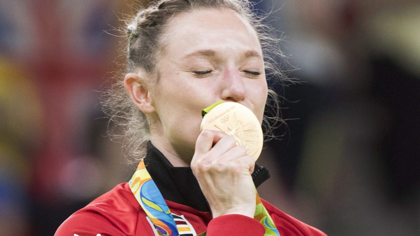 Canada's Rosie MacLennan, from King City, Ont., kisses her gold medal after winning the trampoline gymnastics competition at the 2016 Summer Olympics Friday, August 12, 2016 in Rio de Janeiro, Brazil.THE CANADIAN PRESS/Ryan Remiorz