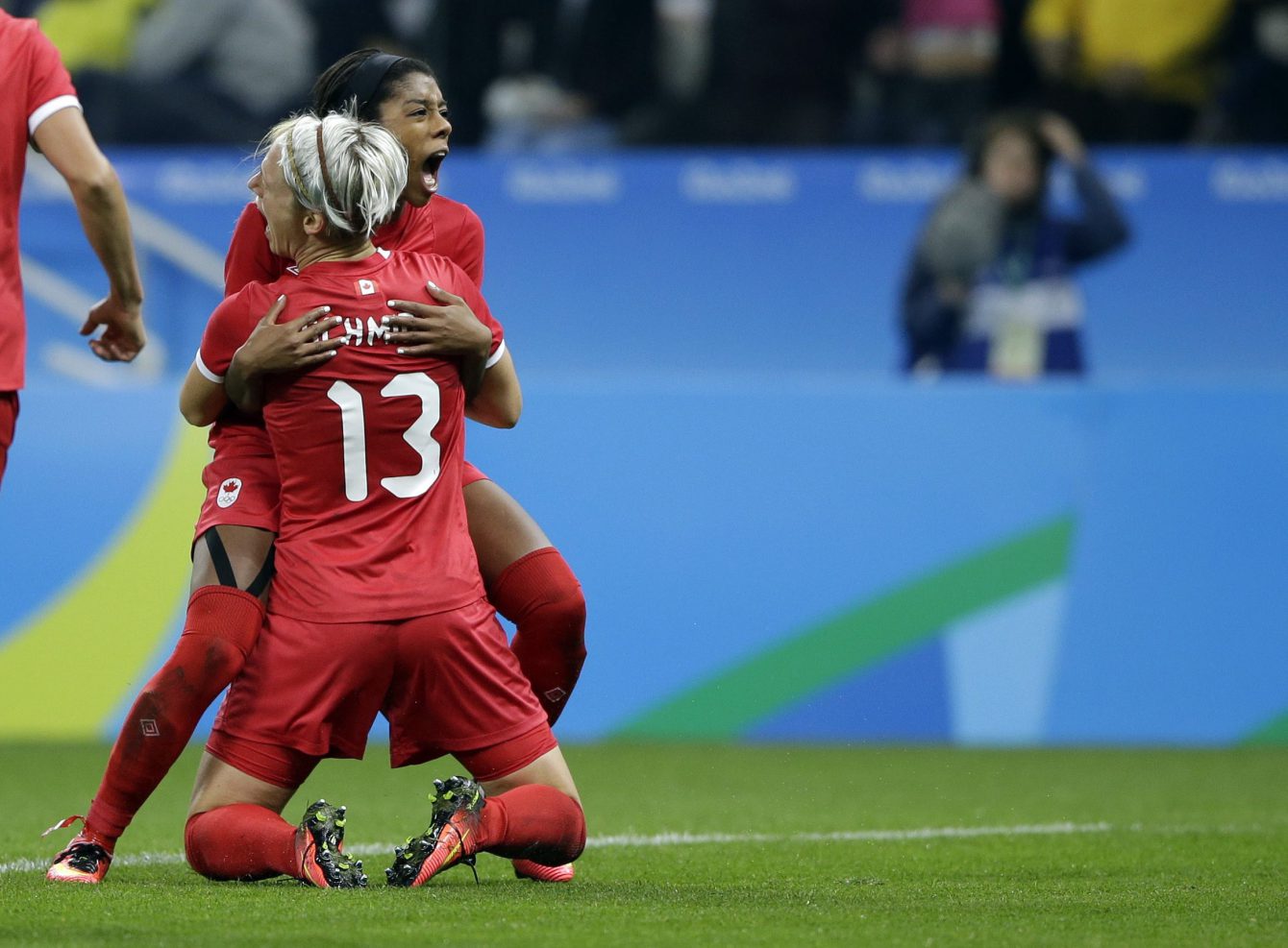 Canada's Sophie Schmidt,, 13, celebrates with teammate Canada's Ashley Lawrence celebrates after scoring her team's first goal during a quarter-final match of the women's Olympic football tournament between Canada and France in Sao Paulo, Brazil, Friday Aug. 12, 2016.(AP Photo/Nelson Antoine)