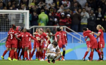 Rio 2016: Women's Soccer France's Amel Majri reacts in dejection as Canada's players celebrate after beating France in a quarter-final match of the women's Olympic football tournament between Canada and France in Sao Paulo, Brazil, Friday Aug. 12, 2016. Canada's won1-0 and went through to the semi-finals.(AP Photo/Nelson Antoine)