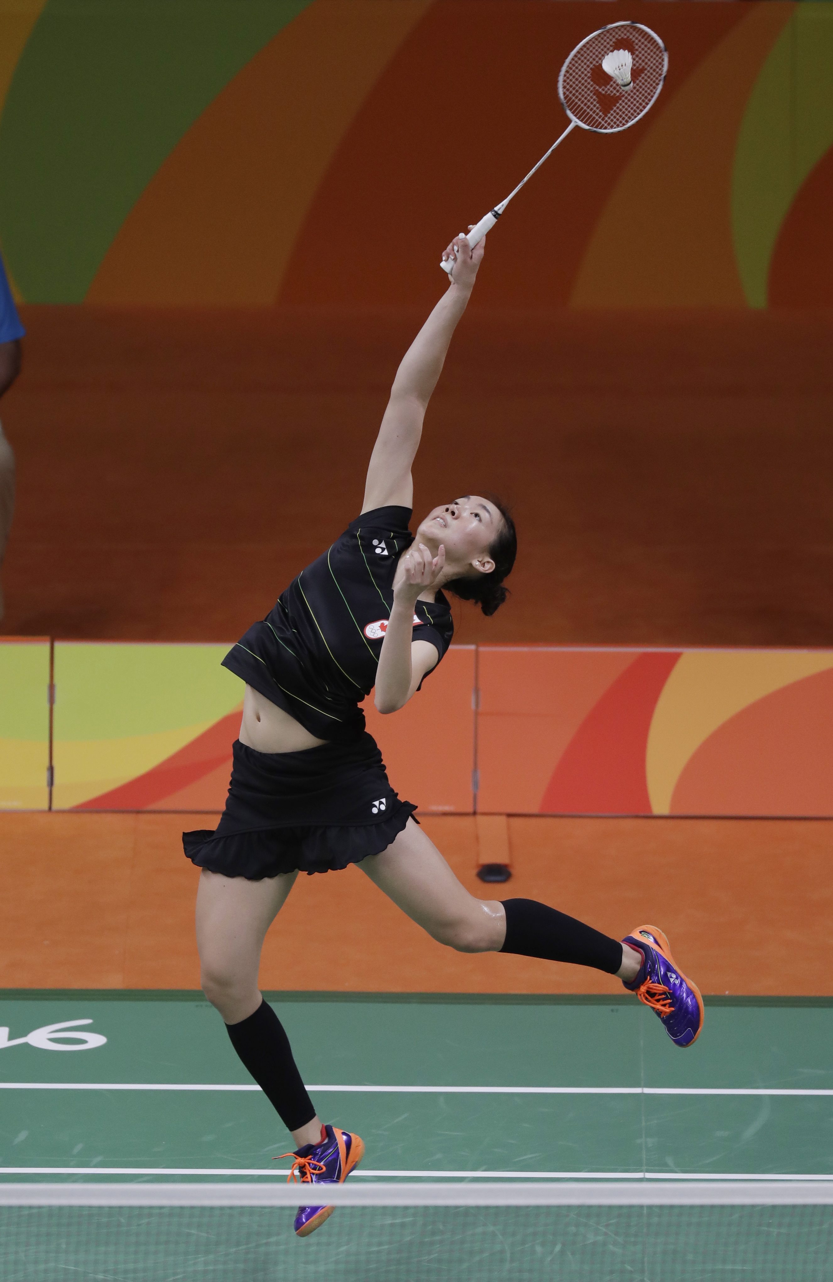 Canada's Michelle Li returns a shot to Hungary's Laura Sarosi during a Women's single match at the 2016 Summer Olympics in Rio de Janeiro, Brazil, Saturday, Aug. 13, 2016. (AP Photo/Kin Cheung)