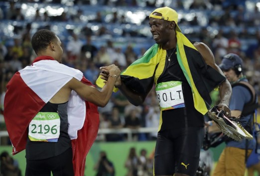 Jamaica's gold medal winner Usain Bolt is congratulated by Canada's Andre De Grasse after the men's 100-meter final during the athletics competitions of the 2016 Summer Olympics at the Olympic stadium in Rio de Janeiro, Brazil, Sunday, Aug. 14, 2016. (AP Photo/Matt Dunham)