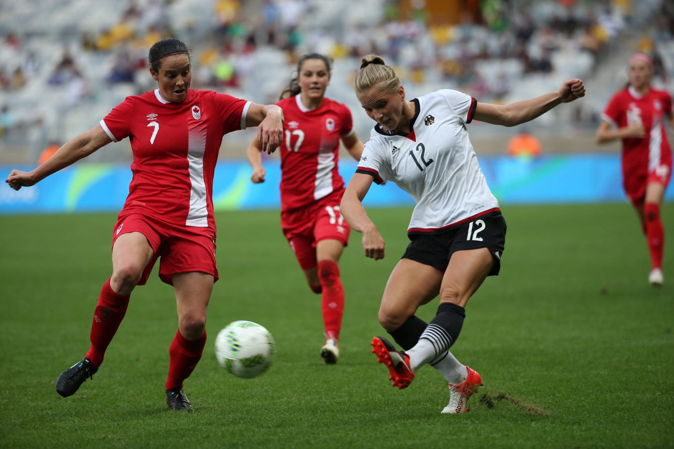 Germany's Tabea Kemme, right, kicks the ball past Canada's Rhian Wilkinson during a semi-final match of the women's Olympic football tournament between Canada and Germany at the Mineirao stadium in Belo Horizonte, Brazil, Tuesday Aug. 16, 2016. (AP Photo/Eugenio Savio)