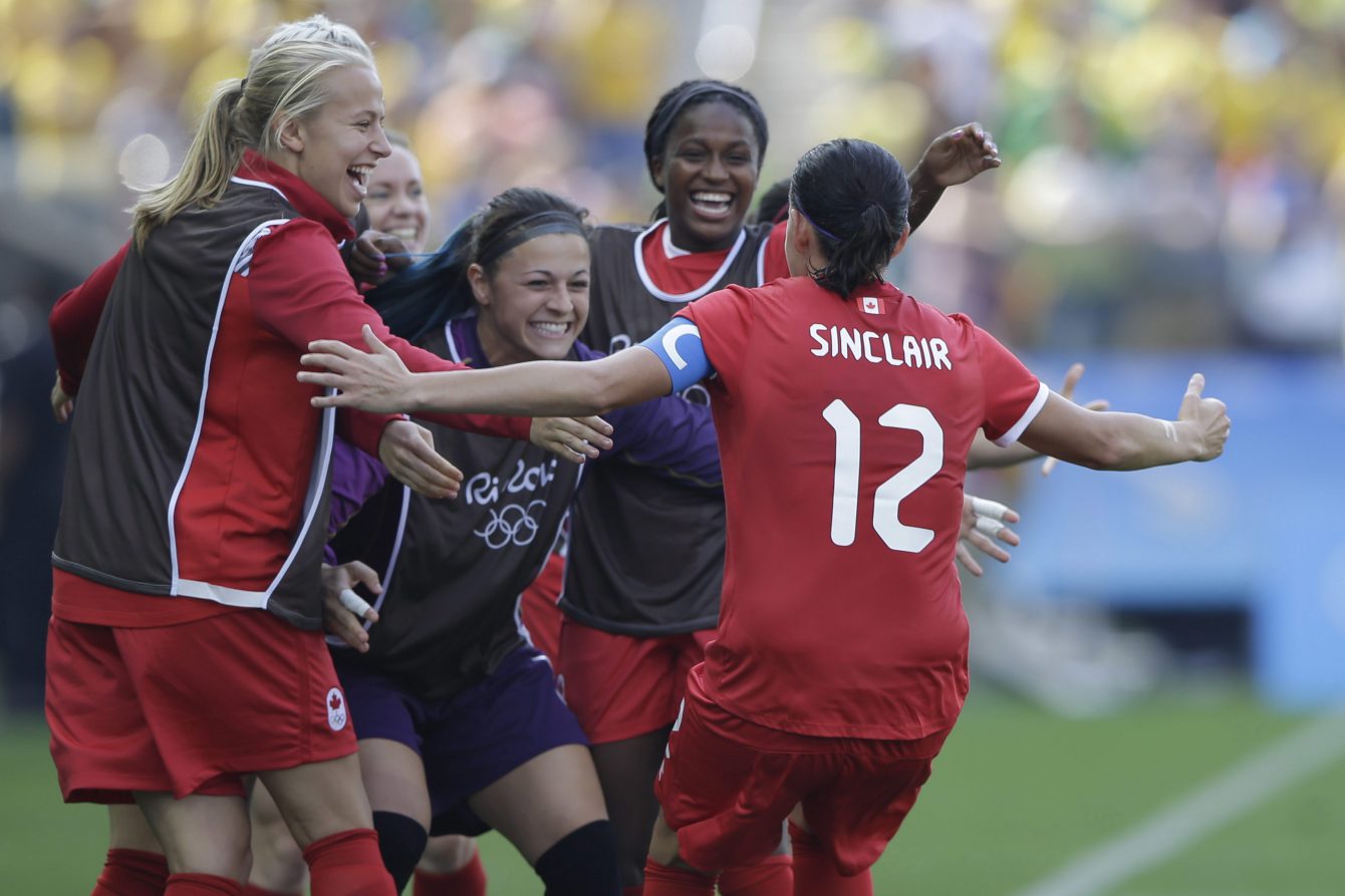 Canada's Christine Sinclair, 12, is congratulated after scoring her side's 2nd goal during the bronze medal match of the women's Olympic football tournament between Brazil and Canada at the Arena Corinthians stadium in Sao Paulo, Friday Aug. 19, 2016. (AP Photo/Nelson Antoine)