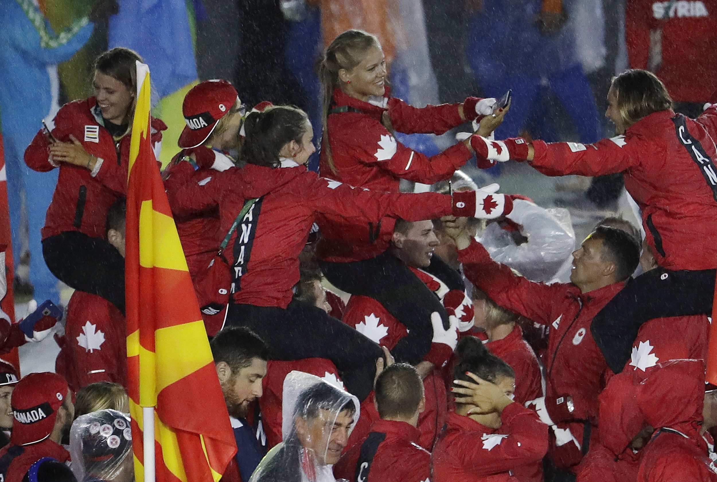 Athletes are carried on the shoulders of teammates of the Canadian team as they march in during the closing ceremony in the Maracana stadium at the 2016 Summer Olympics in Rio de Janeiro, Brazil, Sunday, Aug. 21, 2016. (AP Photo/Natacha Pisarenko)