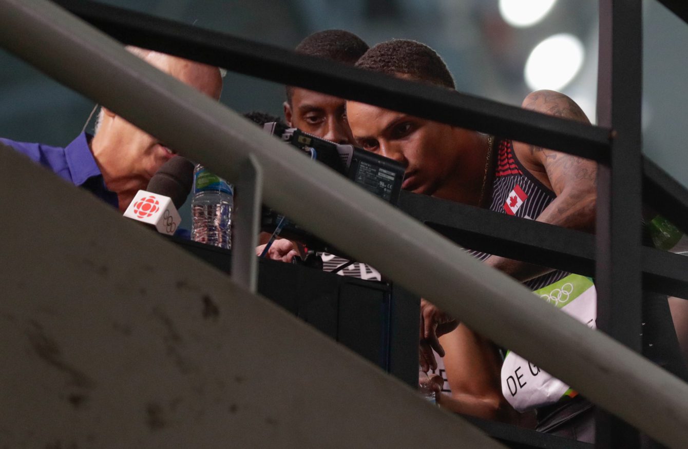 Canada's men's 4x100m relay team consisting of Andre De Grasse, Aaron Brown, Akeem Haynes and Brendon Rodney reviewing the moment in the race that pushed them to bronze. (photo/ Jason Ransom)