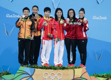 Benfeito and Filion pose with their medals after winning a bronze in the 10m platform synchro dive. (photo/Jason Ransom)