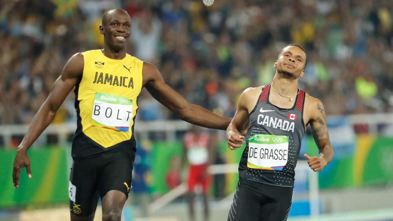 Usain Bolt and Andre De Grasse at the end of their 100m semifinal race on August 14, 2016.