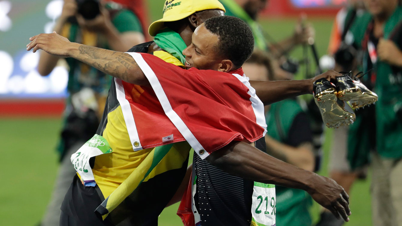 Usain Bolt (left) and Andre De Grasse hug after their respective gold and bronze medal finishes at the Olympic Games in Rio de Janeiro on August 14, 2016.