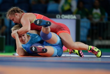 Canada's Erica Wiebe, in red, competes against Kazakhstan's Guzel Manyurova during the women's 75kg freestyle wrestling competition at the 2016 Summer Olympics in Rio de Janeiro, Brazil, Thursday, Aug. 18, 2016. (COC/Jason Ransom)
