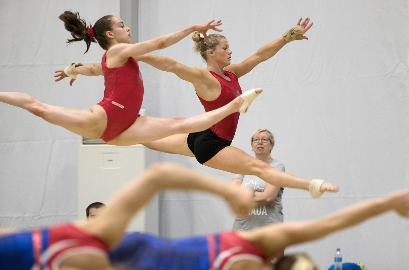Isabela Onyshko, left, and Brittany Rogers warm up during a training session prior to the Olympic games in Rio de Janeiro, Brazil, Sunday, July 31, 2016. COC Photo by Jason Ransom