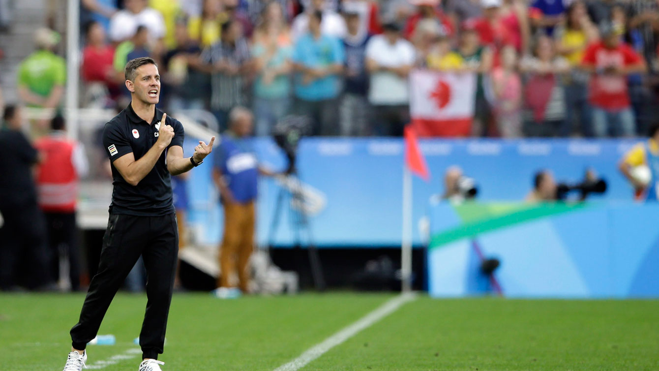 John Herdman instructs his players during Canada's Olympic women's football match against Zimbabwe on August 6, 2016. 