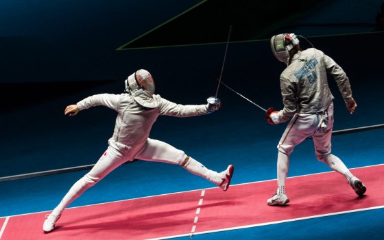 Canada's Joseph Polossifakis competes with Aliaksandr Buikevich of Belarus in their Men's Sabre Individual Table of 32 fencing match.