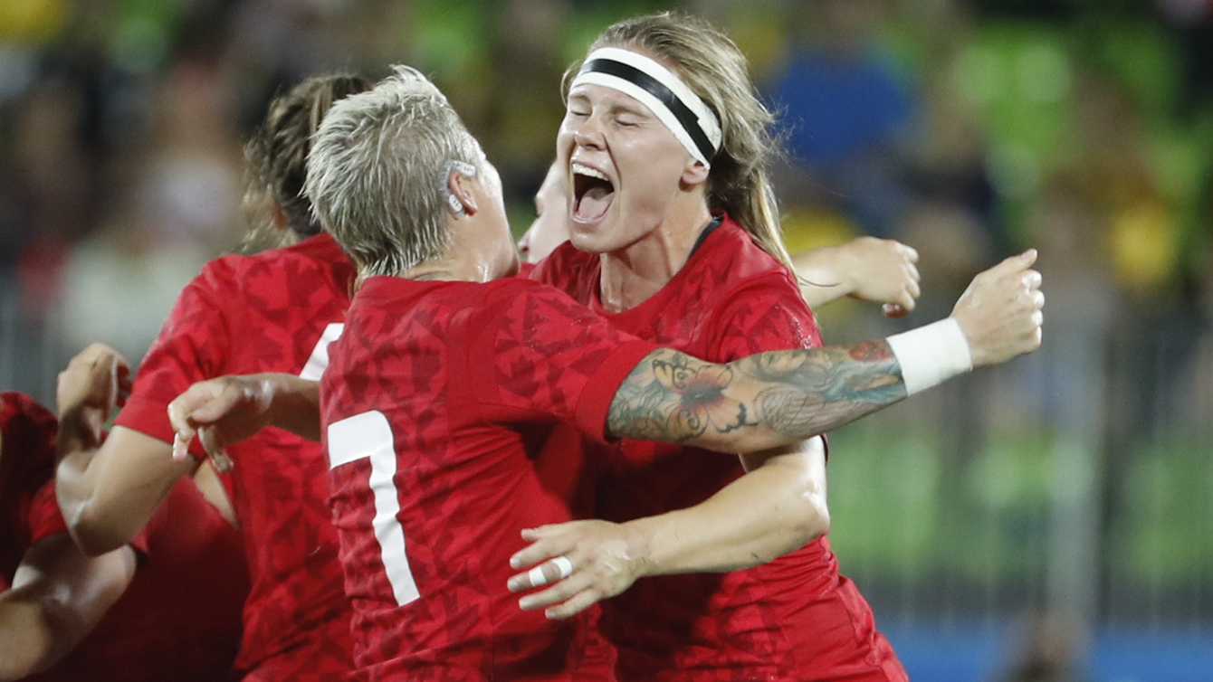 Karen Paquin hugs captain Jen Kish after winning bronze for rugby on August 8, 2016.