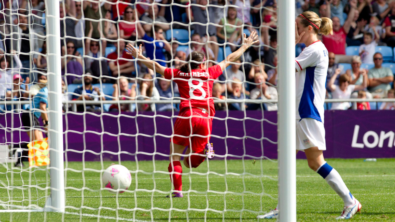 Diana Matheson celebrates scoring a goal.