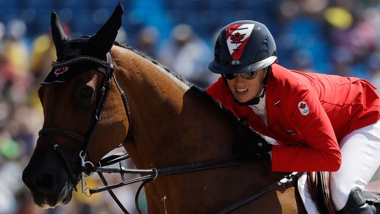 Amy Millar on horse jumping during equestrian event