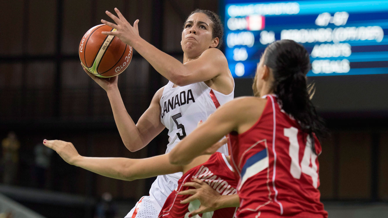 Kia Nurse with the ball trying to get around a defender