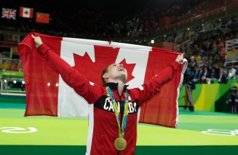 Canada's Rosie MacLennan, from King City, Ont., celebrates after winning the gold medal in the trampoline gymnastics competition at the 2016 Summer Olympics Friday, August 12, 2016 in Rio de Janeiro, Brazil.(photo/Jason Ransom)