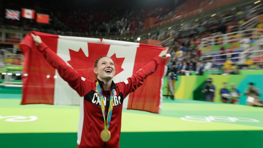 Rosie Holding the Canadian flag laughing at Rio 2016