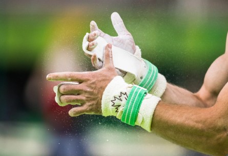 Canada's Scott Morgan puts chalk on his hands before performing on the rings during men's artistic gymnastics qualifying at the Olympic games in Rio de Janeiro, Brazil, Saturday August 6, 2016. COC Photo/Mark Blinch