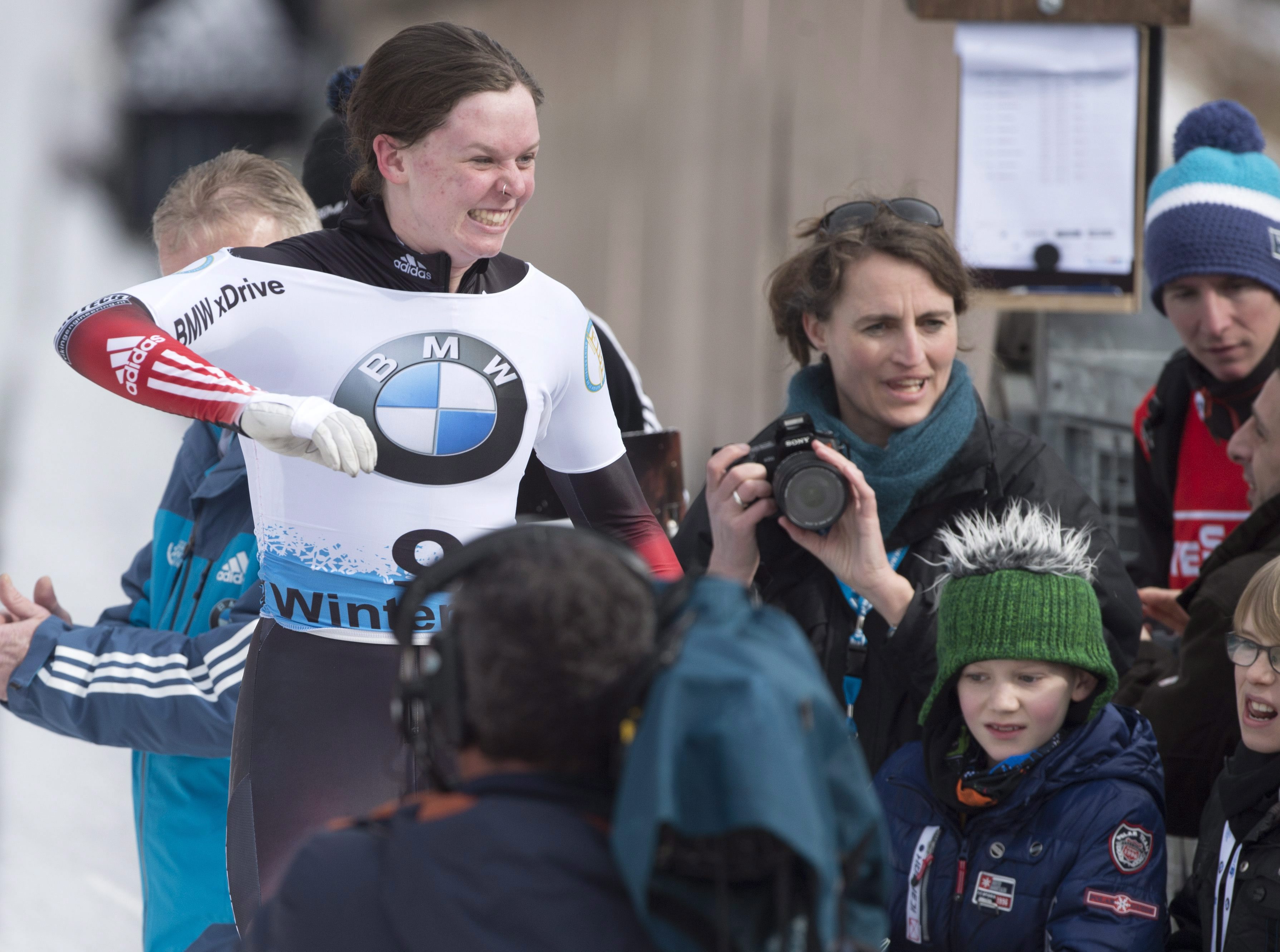 Bronze medallist Elisabeth Vathje of Canada, left, celebrates after the women's skeleton race at the Bobsleigh and Skeleton World Championships in Winterberg, Germany, Saturday, March 7, 2015. (AP Photo/Jens Meyer)