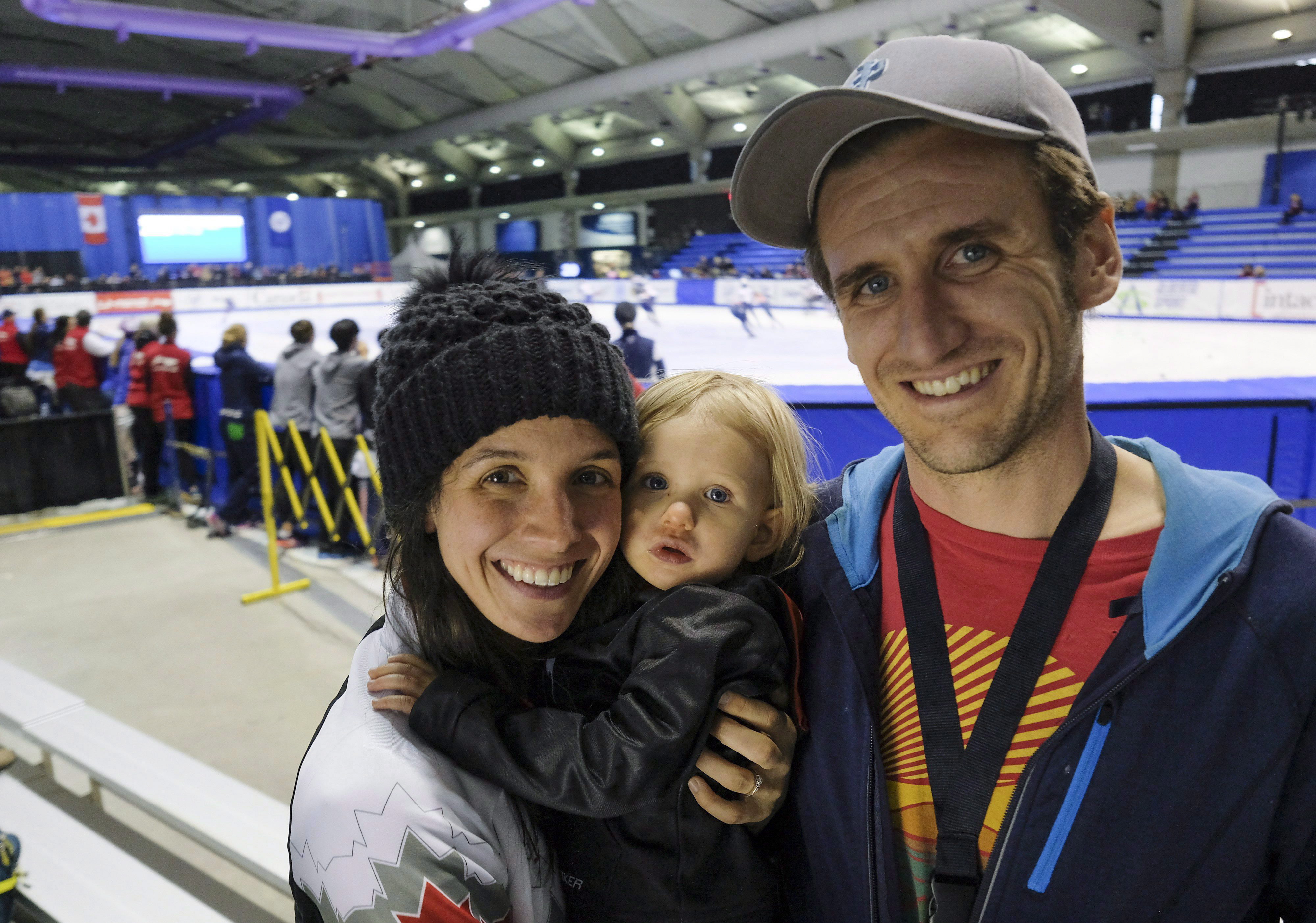 Canada's Marie-Eve Drolet, left, holds her daughter Zoey Crysler, 22 months, with her husband Corey Crysler at the ISU World Cup short track speed skating event in Calgary, Alta., Friday, Nov. 4, 2016.THE CANADIAN PRESS/Jeff McIntosh