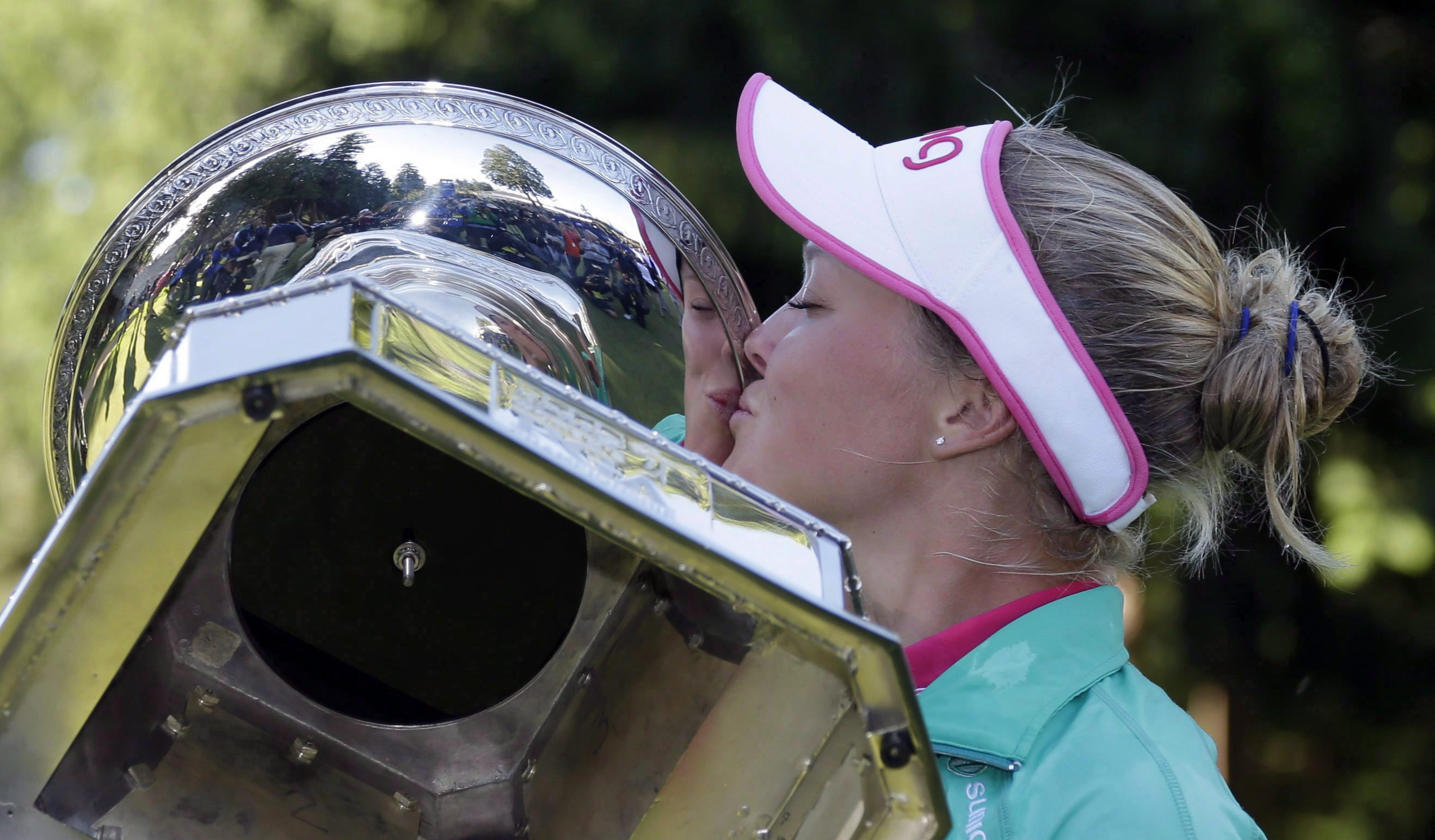 After being prompted by organizers, Brooke Henderson, of Canada, plants a kiss on the championship trophy after winning the Women's PGA Championship golf tournament at Sahalee Country Club on Sunday, June 12, 2016, in Sammamish, Washington. The 19-year-old from Smiths Falls, Ont., packed more into one season than some golfers experience over an entire career. THE CANADIAN PRESS/AP, Elaine Thompson