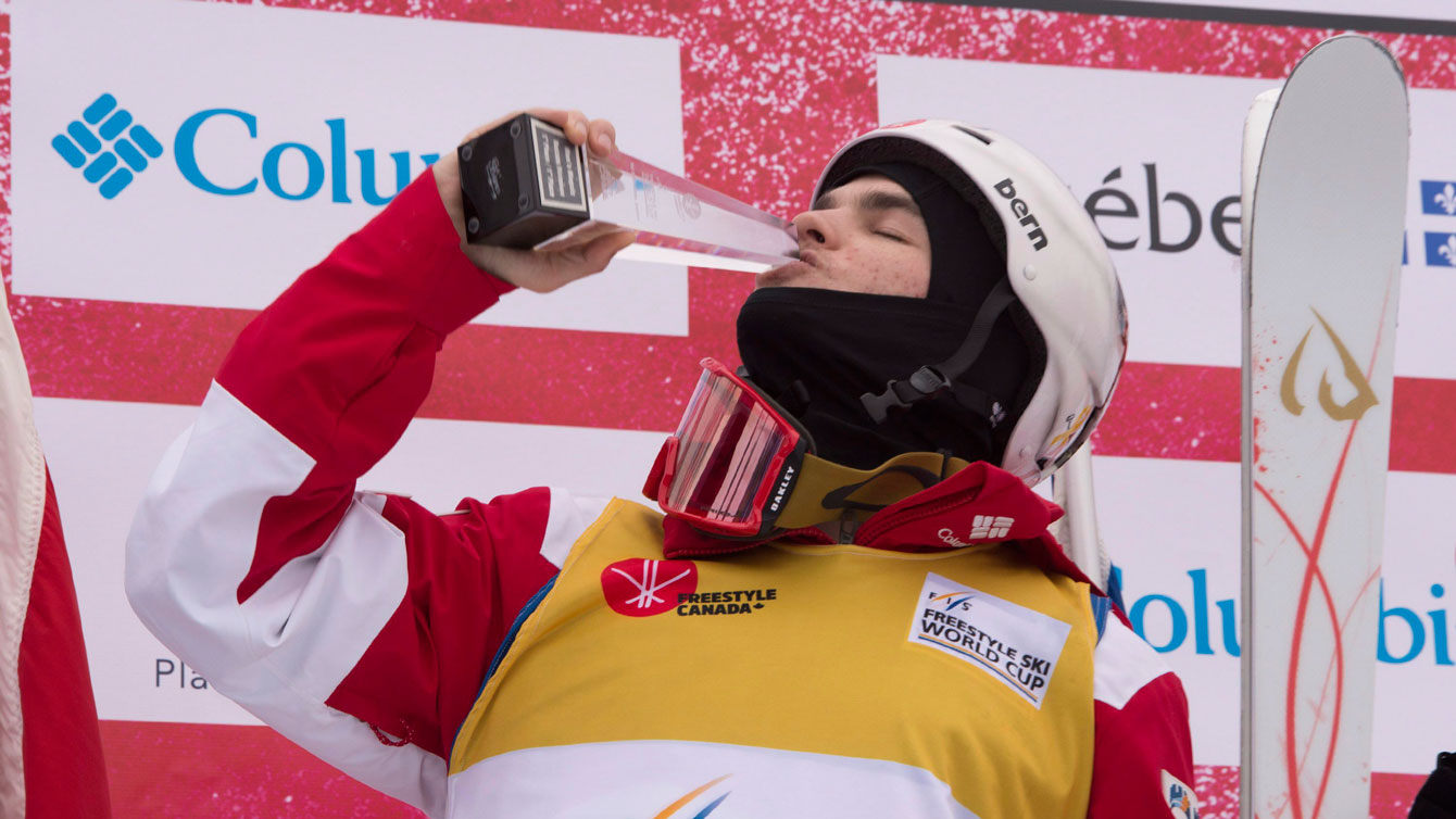 Mikael Kinsgsbury kisses his trophy as he celebrates his victory at the moguls World Cup on January 21, 2017 in St-Come, Que. THE CANADIAN PRESS/Jacques Boissinot