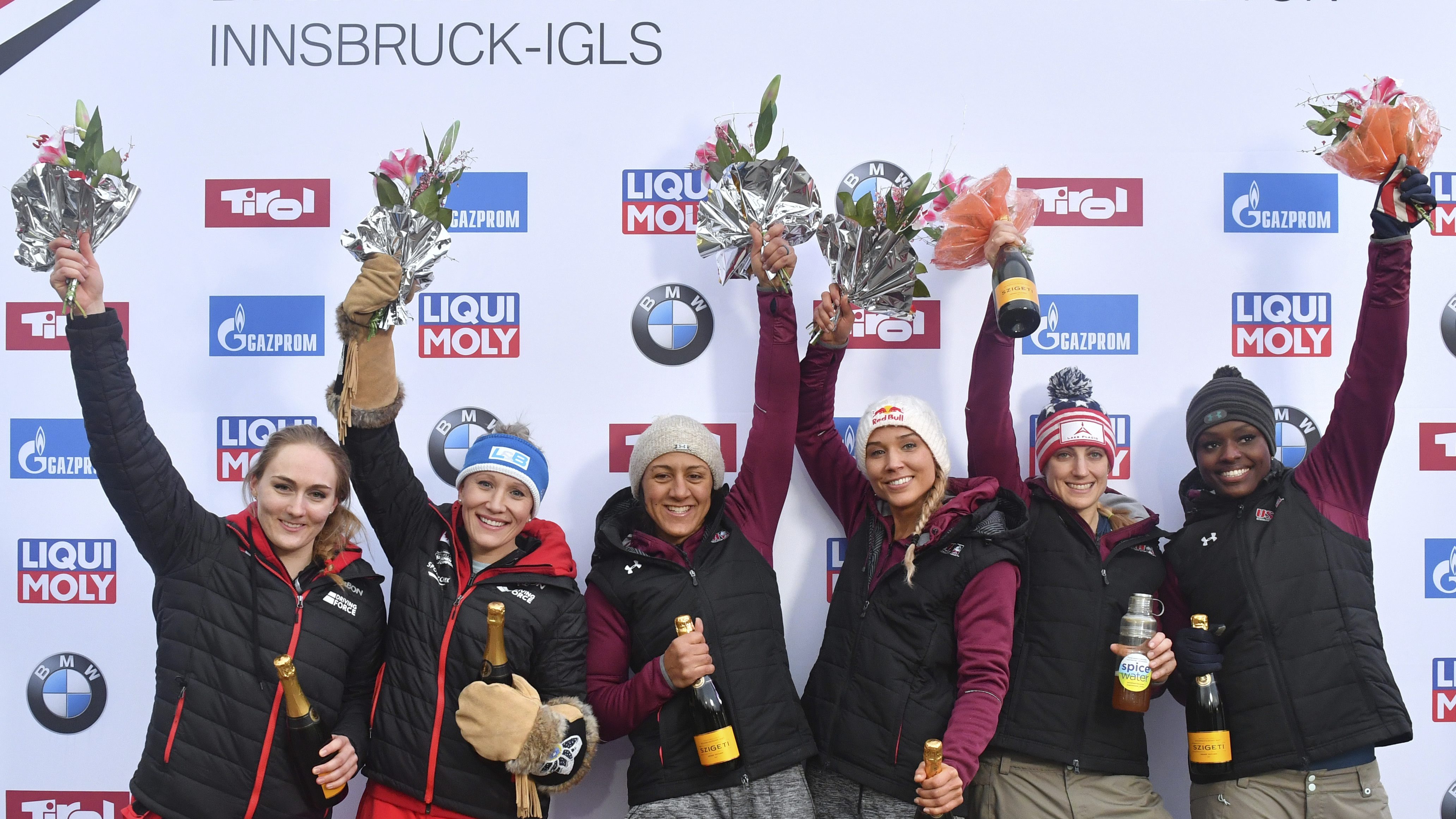 Canada's second placed Melissa Lotholz, from left to right, Kaillie Humphries, the winners Elana Meyers Taylor and Lolo Jones of the United States and third placed Jamie Greubel Poser and Aja Evans of the Unites States celebrate after the women's two-man bobsled World Cup race in Igls, near Innsbruck, Austria, Saturday, Feb. 4, 2017. (AP Photo/Kerstin Joensson)