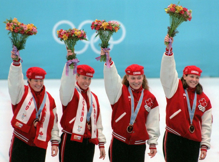 Canada's Short Track Speed Skating relay team Annie Perreault, Tania Vicent, Christine Boudrias and Isabelle Charest, left to right, wave from the podium after winning the Olympic bronze medal in the ladies 3,000m relay Tuesday in Nagano. (CP PHOTO) 1998 (stf/Paul Chiasson)