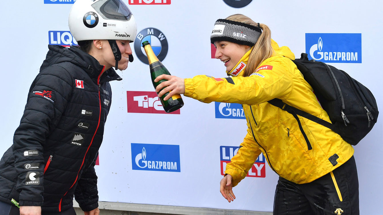 Germany's winner Hermann shares her champagne with Mirela Rahneva (silver) at the Skeleton World Cup race in Igls on Feb. 3, 2017. (AP Photo/Kerstin Joensson)