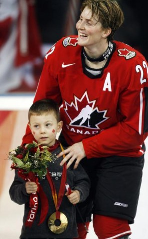 Team Canada's Hayley Wickenheiser puts her gold medal on her son, Noah, after defeating Sweden 4-1 to win the gold medal in womens ice hockey at the 2006 Winter Olympic Monday, Feb. 20, 2006 in Turin. (CP PHOTO/Ryan Remiorz)