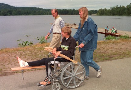 Canadian rowing team member Silken Laumann, accompanied by team doctor Richard Backus and her sister Daniele Laumann Hart. Silken Laumann was visiting the Victoria City Rowing club Tuesday June 9, 1992. In the background Laumann's scull is being adjusted by technicians. (CP PHOTO/Bruce Stotesbury)