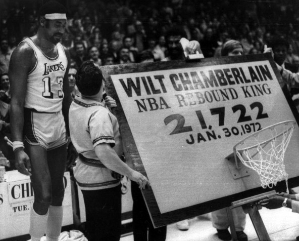 Wilt Chamberlain stands beside a backboard and hoop trophy after being named the all-time leading rebounder in NBA history, in Los Angeles, 1972. ( AP Photo / file )