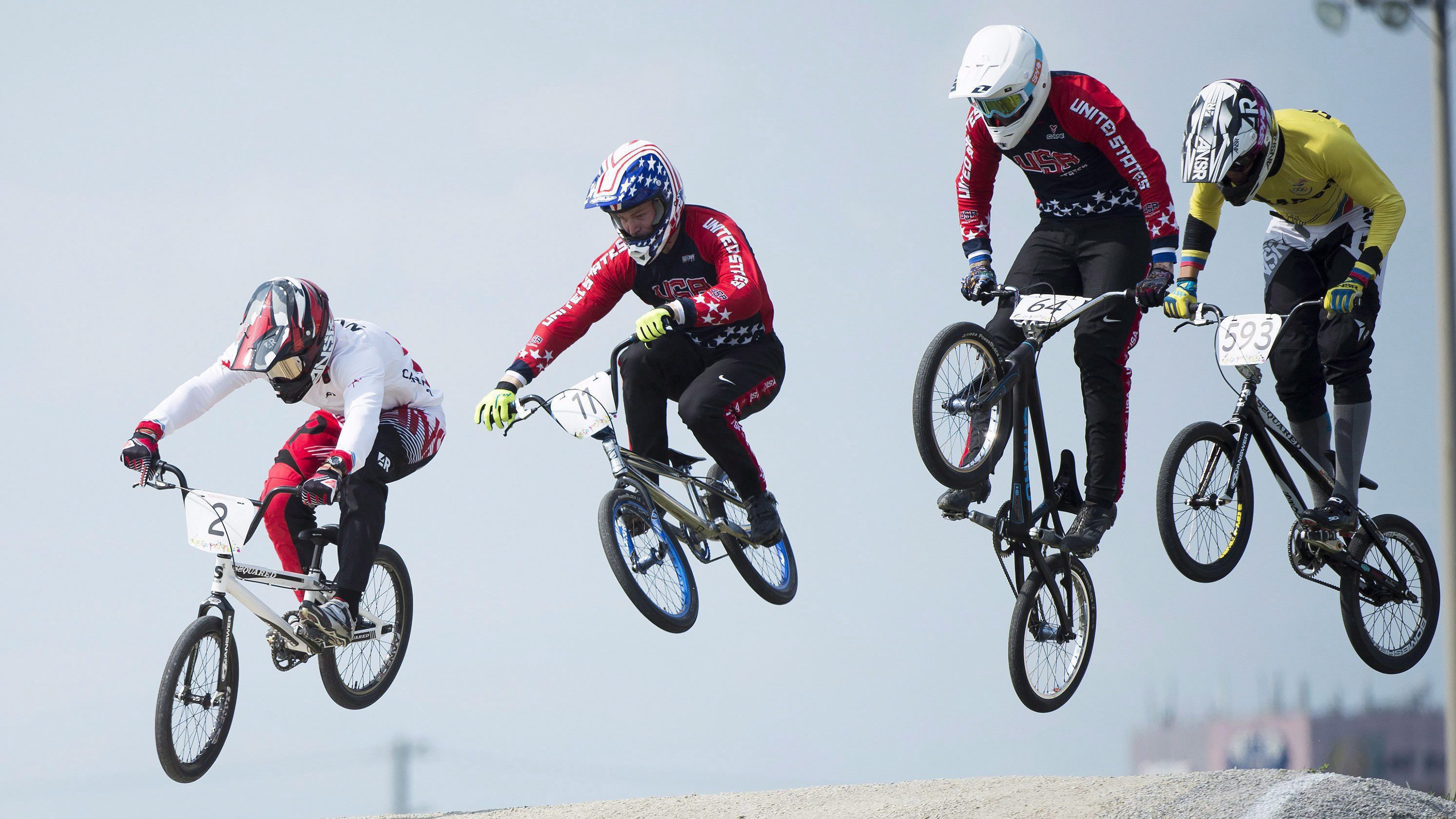 Canadian Tory Nyhaug, left, leads the pack over a jump during men's BMX finals at the Pan American Games in Toronto on Saturday, July 11, 2015. Nyhaug went on the win gold.