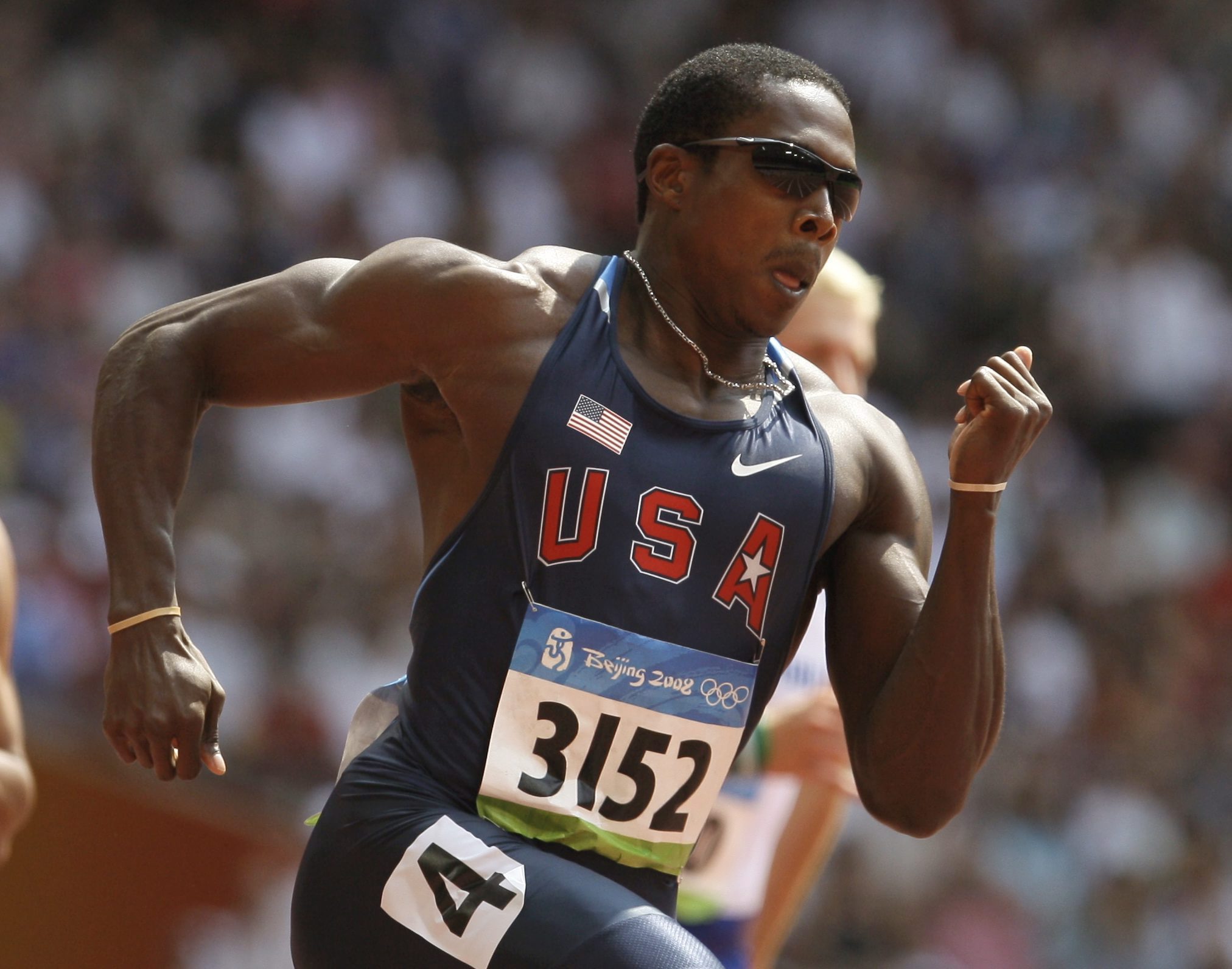In this Aug. 18, 2008, file photo, Shawn Crawford of the United States competes in a heat of the men's 200-meter race during the athletics competitions in the National Stadium at the Beijing 2008 Olympics in Beijing. In the finals Crawford finished fourth, only to move up two spots when Netherlands Antilles sprinter Churandy Martina and American Wallace Spearmon were disqualified for running outside their lanes. But each time Crawford looked at his medal, he felt stabs of guilt. So he gave it back to Martina, who in his opinion beat him fair and square, even though the rules said differently(AP Photo/David J. Phillip, File)