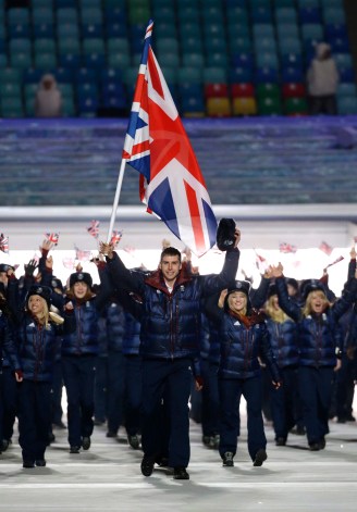 Jon Eley of Britain carries the national flag as he leads the team during the opening ceremony of the 2014 Olympic Winter Games in Sochi, Russia, Friday, Feb. 7, 2014. (AP Photo/Mark Humphrey)
