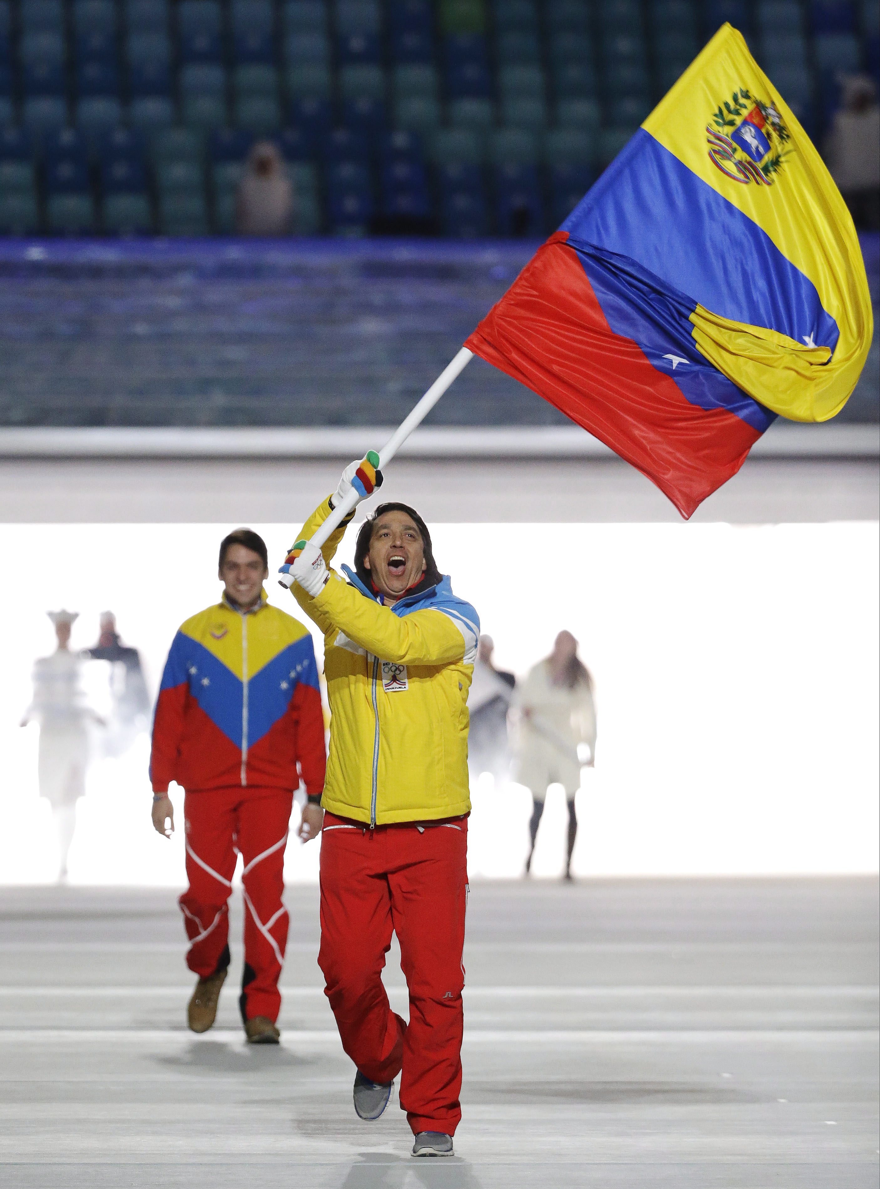 Antonio Pardo of Venezuela carries the national flag as he leads the team during the opening ceremony of the 2014 Olympic Winter Games in Sochi, Russia, Friday, Feb. 7, 2014. (AP Photo/Mark Humphrey)