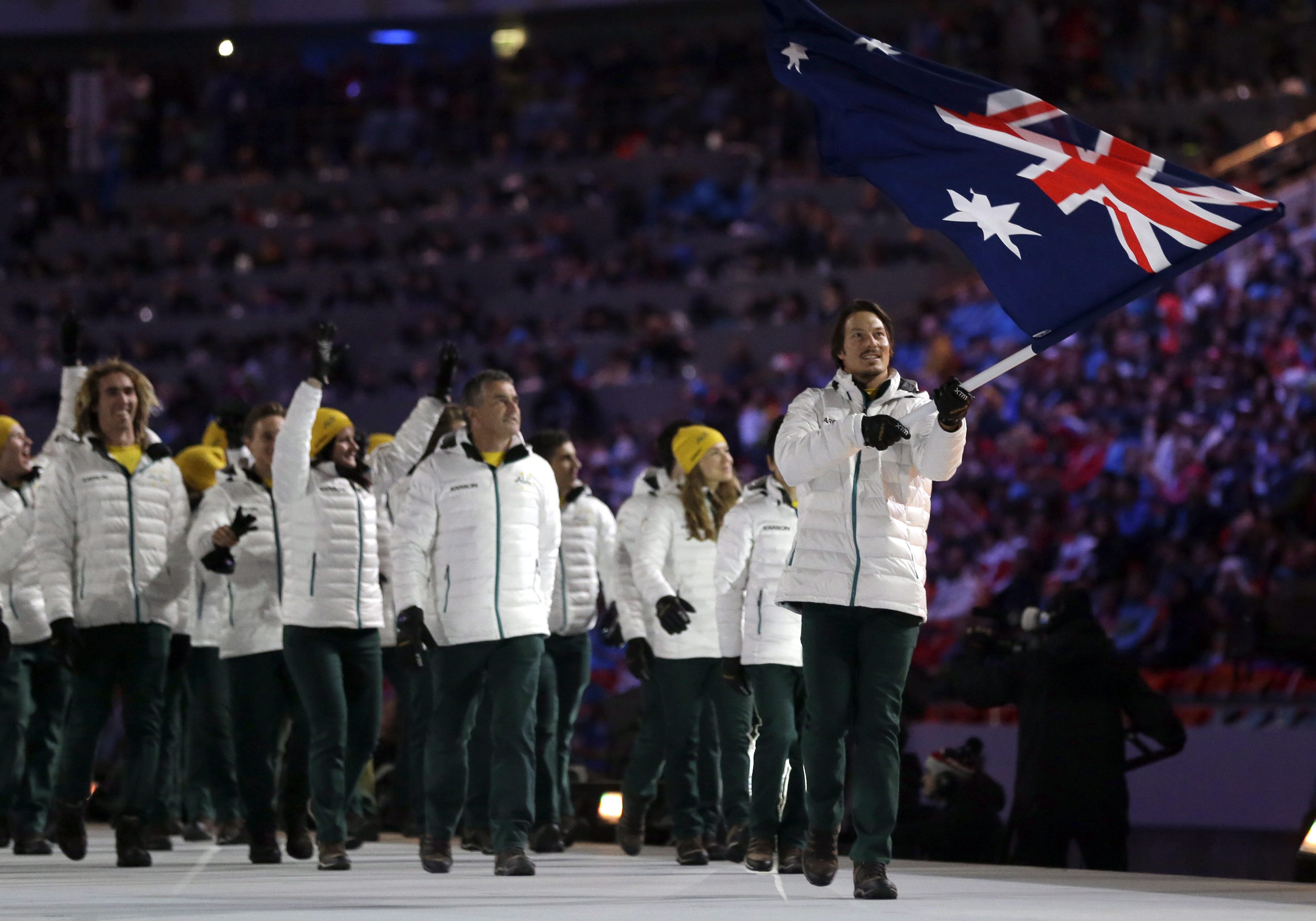 Alex Pullin of Australia carries the national flag as he leads the team during the opening ceremony of the 2014 Olympic Winter Games in Sochi, Russia, Friday, Feb. 7, 2014. (AP Photo/Patrick Semansky)
