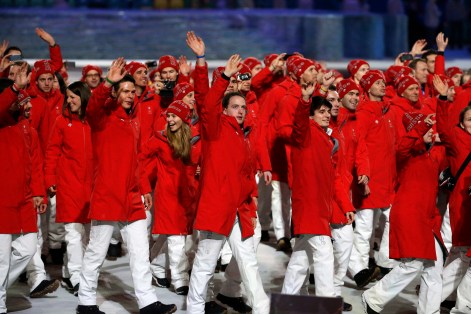 Athletes from Switzerland wave to spectators as they arrive during the opening ceremony of the 2014 Olympic Winter Games in Sochi, Russia, Friday, Feb. 7, 2014. (AP Photo/Mark Humphrey)