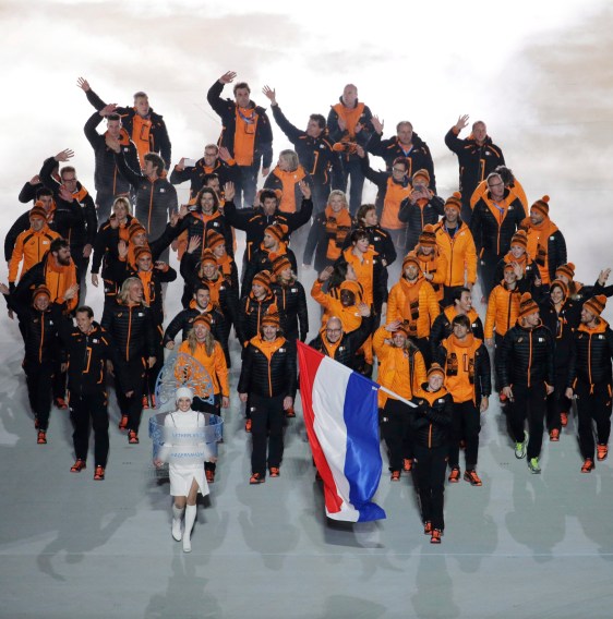 Jorien ter Mors of Netherlands holds her national flag and enters the arena with teammates during the opening ceremony of the 2014 Olympic Winter Games in Sochi, Russia, Friday, Feb. 7, 2014. (AP Photo/Charlie Riedel)