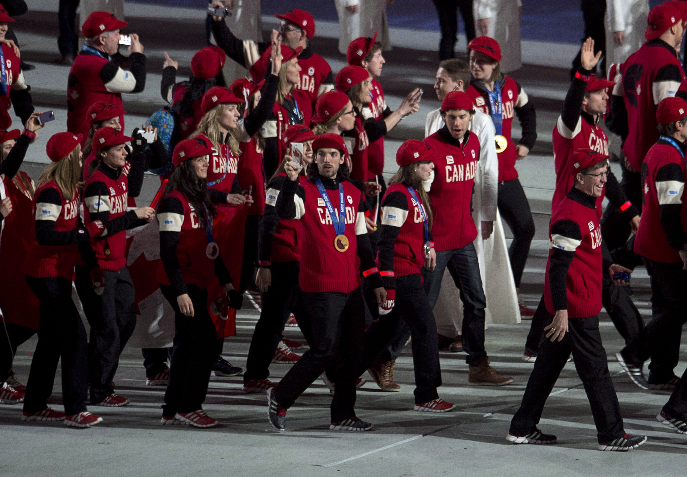 Members of the Canadian team enter the stadium for the closing ceremony for the Sochi 2014 Olympic Winter Games Sunday February 23, 2014 in Sochi, Russia. THE CANADIAN PRESS/Adrian Wyld