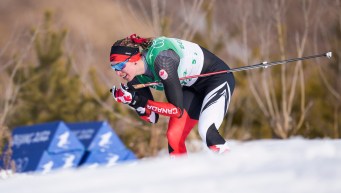 Dahria Beatty glides on a downhill in a cross country skiing race