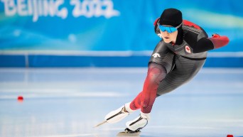 Heather McLean skates around a curve in a speed skating race