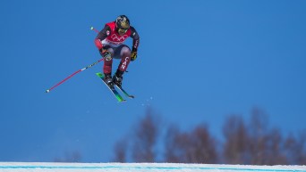 Kevin Drury prepares to land a jump on a ski cross course