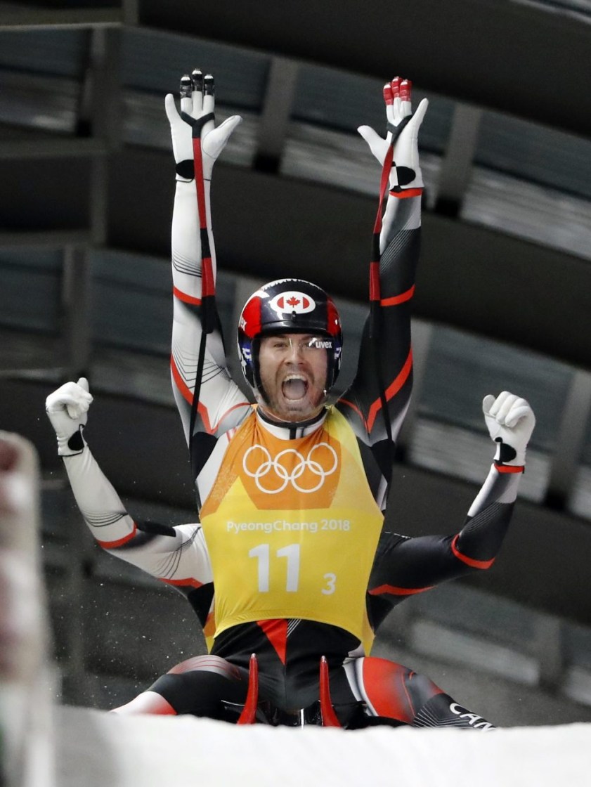 Tristan Walker and Justin Snith, of Canada, react in the finish area after Canada won the silver medal in the luge team relay at the 2018 Winter Olympics in Pyeongchang, South Korea, Thursday, Feb. 15, 2018. (AP Photo/Andy Wong)