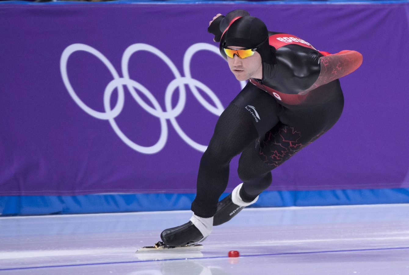 Vincent De Haitre skates in front of Olympic rings