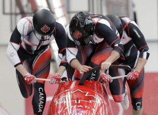 Driver Justin Kripps, Jesse Lumsden, Alexander Kopacz and Oluseyi Smith of Canada start their heat on the first day of four-man bobsled competition at the 2018 Winter Olympics in Pyeongchang, South Korea, Saturday, Feb. 24, 2018. (AP Photo/Wong Maye-E)