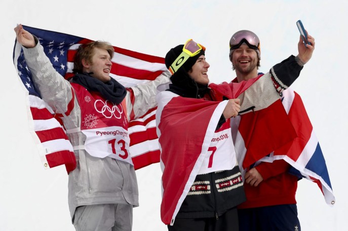 Gold medal winner Sebastien Toutant, of Canada, is flanked by silver medal winner Kyle Mack, of the United States, left, and bronze medal winner Billy Morgan, of Great Britain, during the venue ceremony for the men's Big Air snowboard competition at the 2018 Winter Olympics in Pyeongchang, South Korea, Saturday, Feb. 24, 2018. (AP Photo/Matthias Schrader)